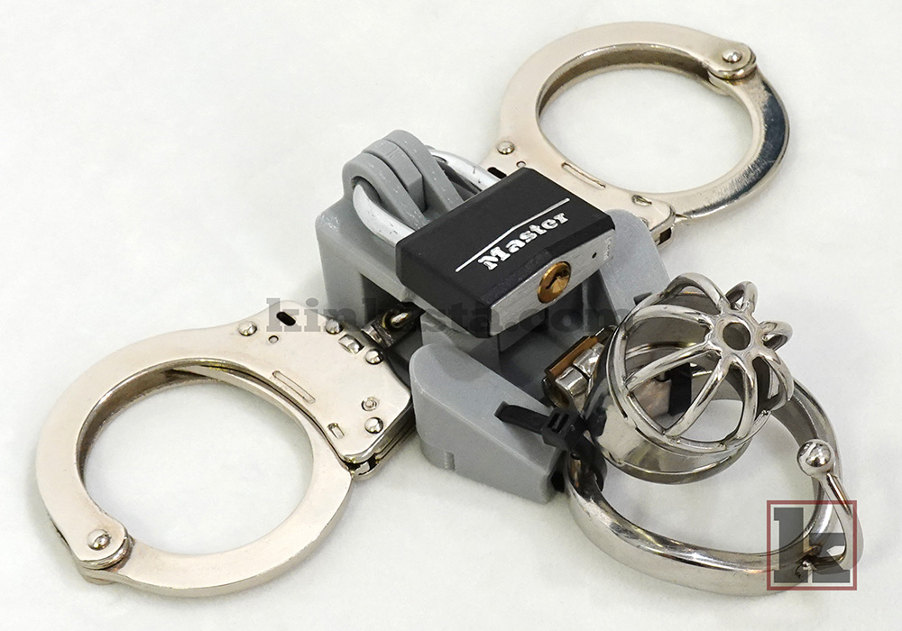 Kinkista Cuff-to-Cage Anchor attached to chastity cage base ring with dual-arm structure