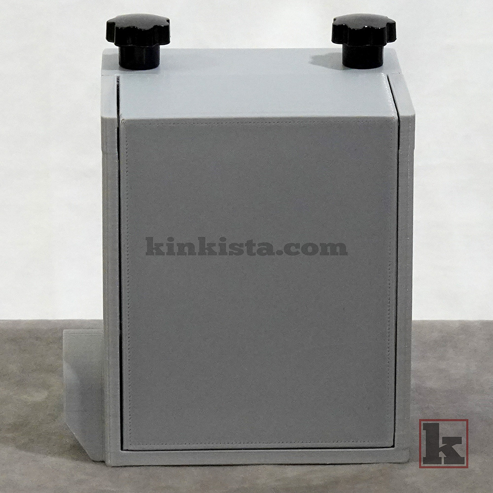 Rear view of BDSM emergency keybox with press-lock securing keys during unattended restraint scenes