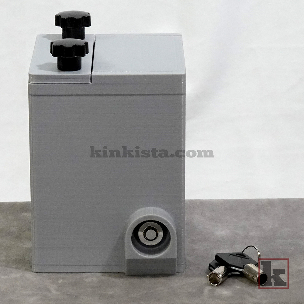 BDSM emergency keybox for control-in-absence power exchange, side view showing press-lock with protective shroud